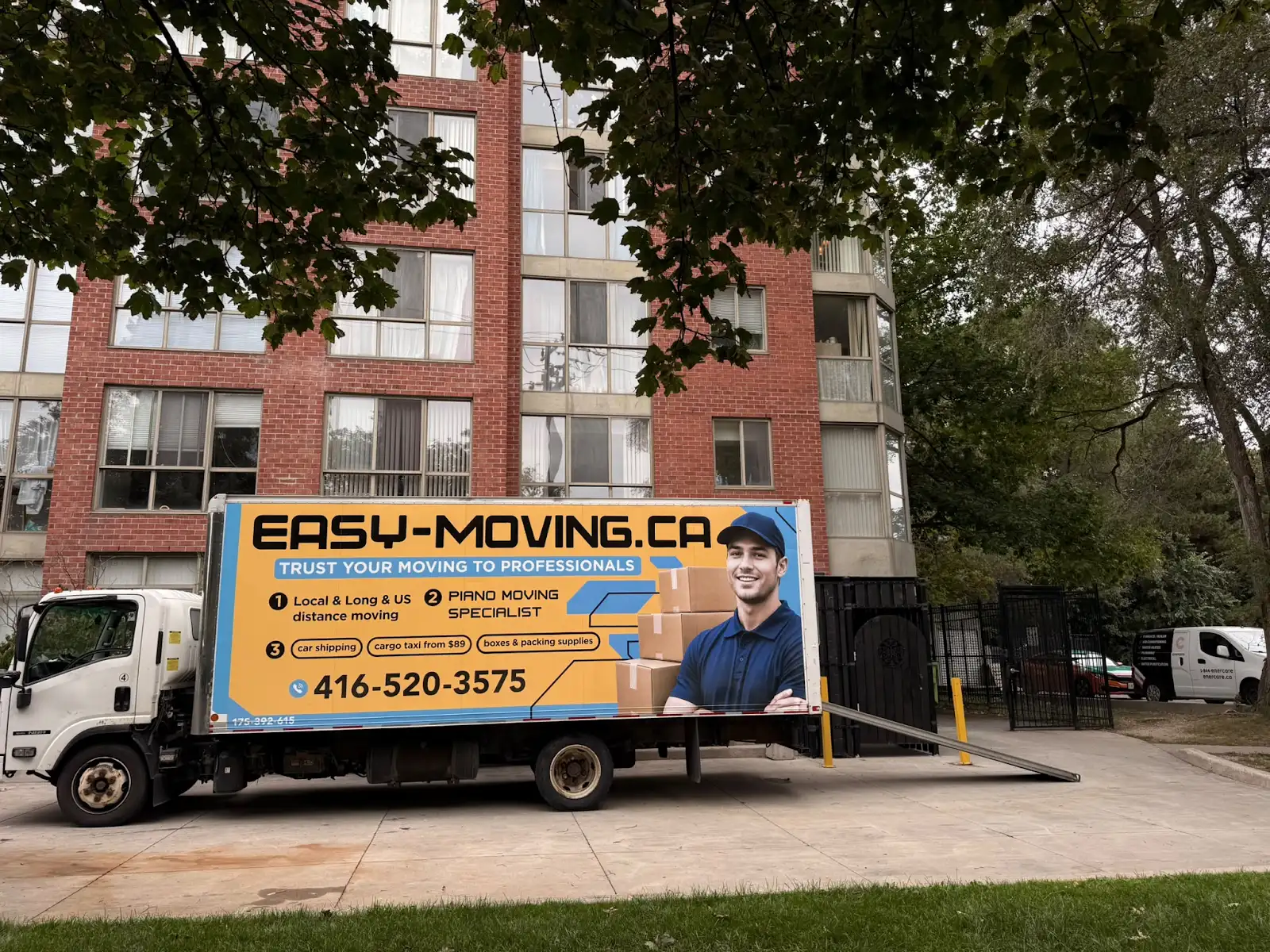 Easy Moving branded truck outside a residential building